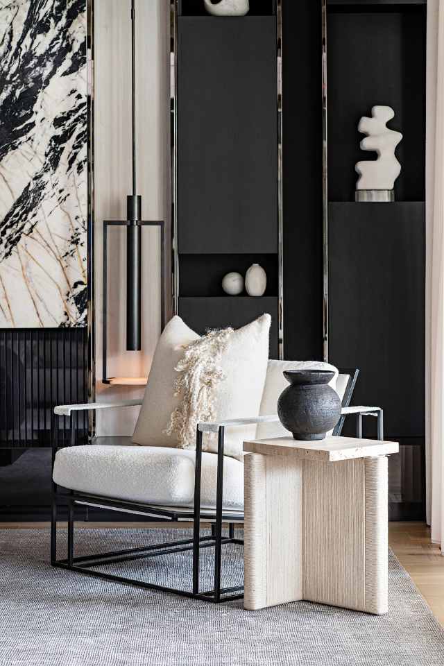 focal point lighting in black and white designer living room with marble feature wall